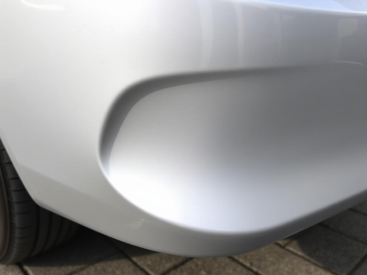 Same bumper corner repainted and blended after a smart repair